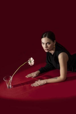 Studio product shoot featuring silver jewelry on neutral backdrop, controlled lighting with soft shadows.