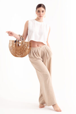 “Female model holding handbag wearing neutral-tone outfit – NYC e-commerce fashion photography studio.”