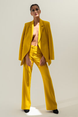 “Female model wearing white minimalist dress – professional studio product photography for clothing brands.”