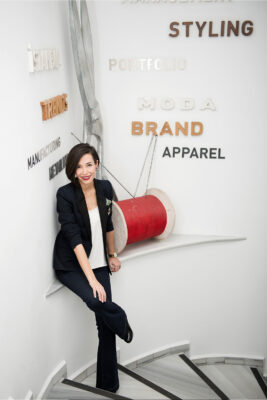 Professional branding photo of a woman in business attire sitting on stairs — corporate portrait