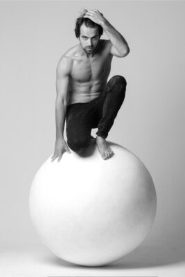 Creative portrait of a man sitting in colorful light for personal branding